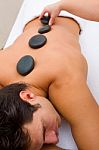 Man Having Hot Stone Massage Stock Photo