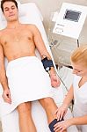 Man In Beauty Center Having Muscle Mass Check Stock Photo