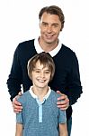 Man In Blue Pullover Posing With His Son Stock Photo