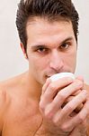 Man In Spa Holding Cup Near Mouth Stock Photo