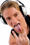 Man Listening Music With Tongue Out Stock Photo
