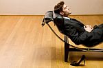 Man Lying On Chaise Longue Stock Photo
