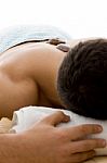 Man Relaxing With Stone Treatment Stock Photo