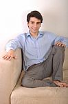 Man Sitting On The Couch Stock Photo