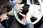 Man Using Mobile Phone While Driving Stock Photo