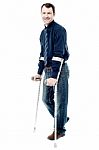 Man Walking With Crutches Isolated On White Stock Photo