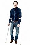 Man Walking With Crutches Isolated On White Stock Photo