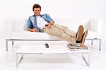 Man Watching Tv On Sofa Remote Stock Photo