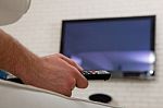 Man Watching Tv With Remote Control Stock Photo