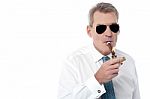 Mature Businessman Smoking A Cigar Stock Photo