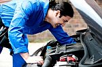 Mechanic Checking Under The Car Engine Stock Photo