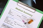 Medical Record And Syringe With Medicine Bottles Stock Photo