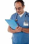 Medical Specialist Studying Report Stock Photo