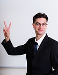 Middle Eastern Business Man Showing Victory Sign Stock Photo