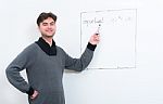 Middle Eastern Teacher Pointing On Whiteboard Stock Photo
