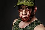 Military Style Camouflage On The Soldier's Face Stock Photo