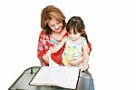 Minority Woman And Her Daughter Reading The Bible Stock Photo