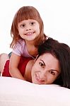 Mom And Her Baby Girl Lying On Bed Stock Photo