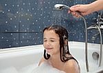 Mom Pours A Little Girl Out Of The Shower Stock Photo
