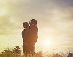 Mother And Daughter On Sunset Watching On Sky Stock Photo