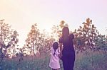 Mother And Daughter On Sunset Watching On Sky Stock Photo