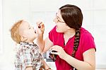 Mother Feeding Child With Grapes Stock Photo