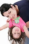 Mother Playing With Her Daughter And Holding Her Upside Down Stock Photo