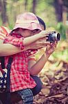Mother Teaching Lovely Asian Daughter Taking Photos. Outdoors Stock Photo