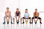 Multiethnic Group Of People Doing Kettlebell Crossfit Exercise Stock Photo