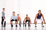 Multiethnic Group With Weightlifting Bar Workout In Fitness Cent Stock Photo
