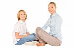 Mum And Son Sat On The Floor Smiling Isolated On White Backgroun Stock Photo