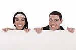Newly Married Couple Standing Behind The Board Stock Photo