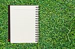 Notebook On Grass Stock Photo