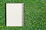 Notebook On Grass Stock Photo