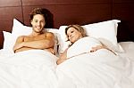 Nude Couple Relaxing In Bed Stock Photo