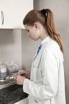 Nurse In The Office Close To The Desktop Stock Photo