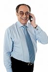 Old Businessman Attending Phone Stock Photo