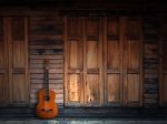 Old Classic Guitar On Wood Wall Stock Photo