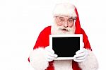 Old Cute Santa Shoeing Tablet Pc Stock Photo