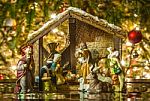 Old Handmade Nativity Scene In Front Of A Christmas Tree Stock Photo