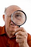 Old Man Looking Through Lens Stock Photo