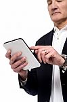 Old Man Using His Tablet Pc Stock Photo