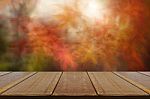 Old Wood Counter With Blurred Autumn Leaves Background Stock Photo