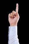 One Finger Raised On The Black Background Stock Photo