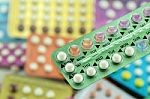 Oral Contraceptive Pill On Pharmacy Counter With Colorful Pills Stock Photo