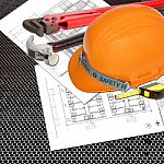 Orange Helmet Of Relate Or Rescue Constructor With Blueprints Stock Photo