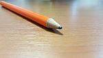 Orange Pencil On Wooden Desk Stock Photo
