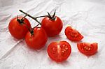 Organic Fresh Cherry Tomatoes On White Paper Background Stock Photo