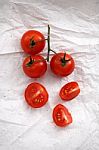 Organic Fresh Cherry Tomatoes On White Paper Background Stock Photo