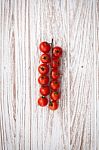 Organic Fresh Cherry Tomatoes On White Wooden Background Stock Photo